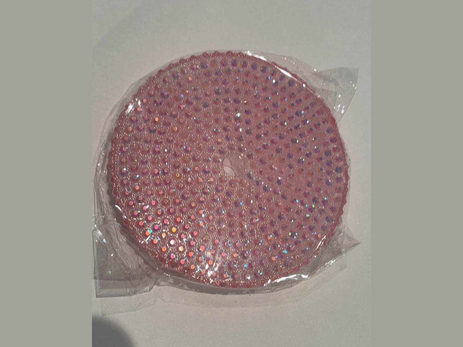 Pink 24oz cup lid decorated with rainbow-reflecting iridescent rhinestones