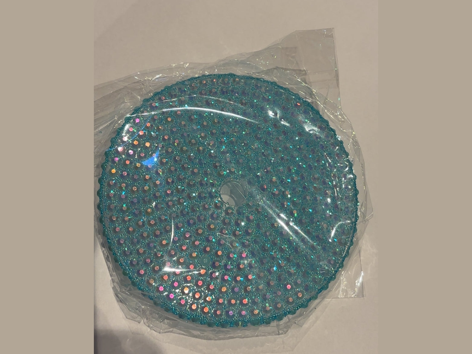Teal 24oz cup lid fully adorned with dense iridescent rhinestones and straw hole
