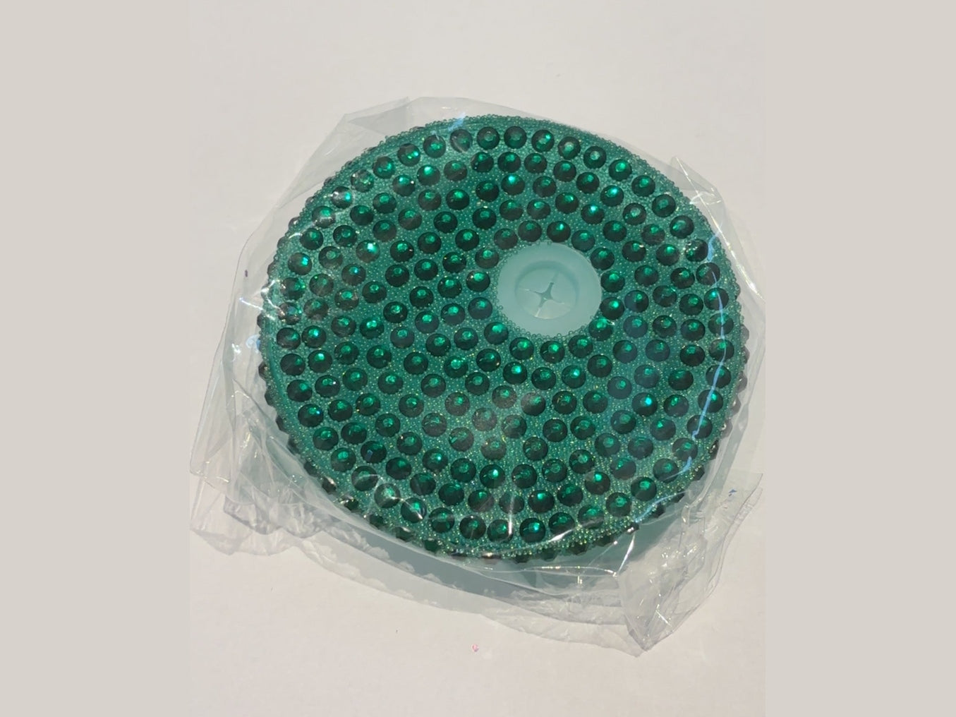 Teal green faceted rhinestone 16oz lid on glitter base with star cutout in clear packaging