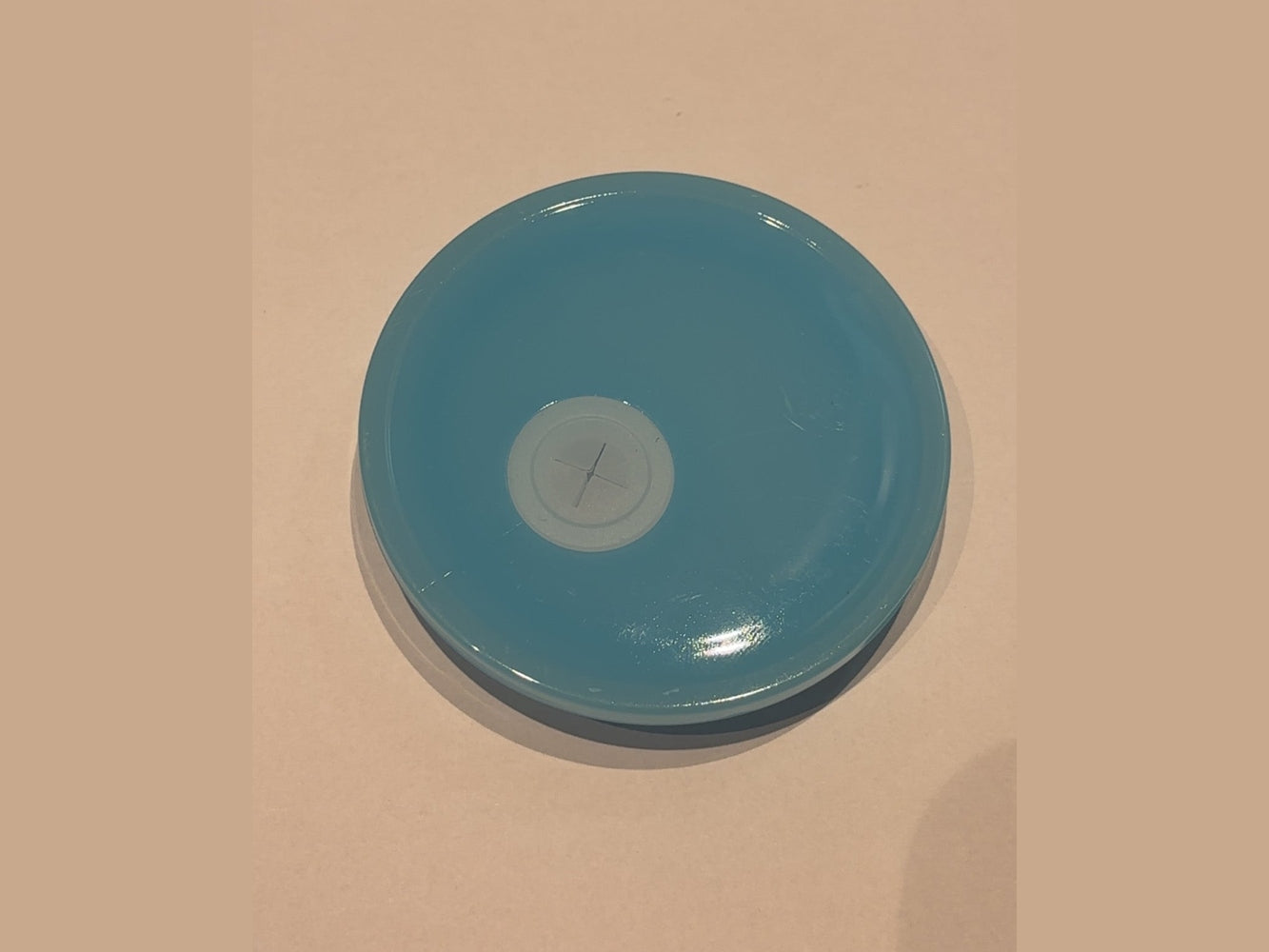 Solid light blue glossy 16oz cup lid with smooth surface and cross-shaped straw opening