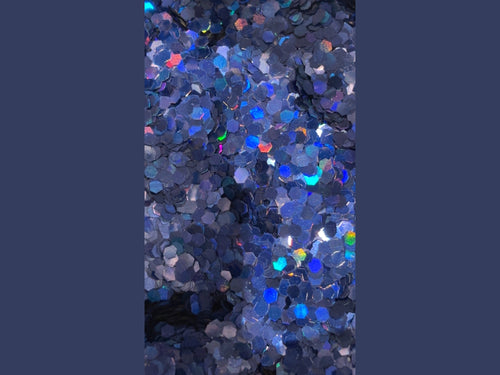 Blue hexagonal glitter with iridescent red green yellow cyan reflections