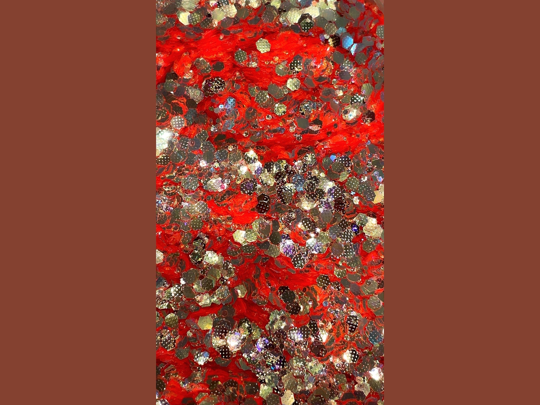 Crimson Frost orange glitter yarn with gold color shift and iridescent hexagonal sparkle