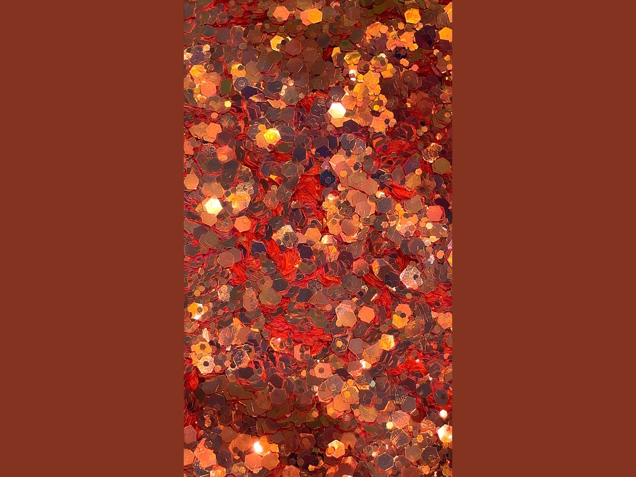 Nova chunky orange-red to bronzy-gold hexagonal glitter with fibrous red base