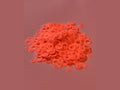 Orange glow in the dark bubble rings on pink surface