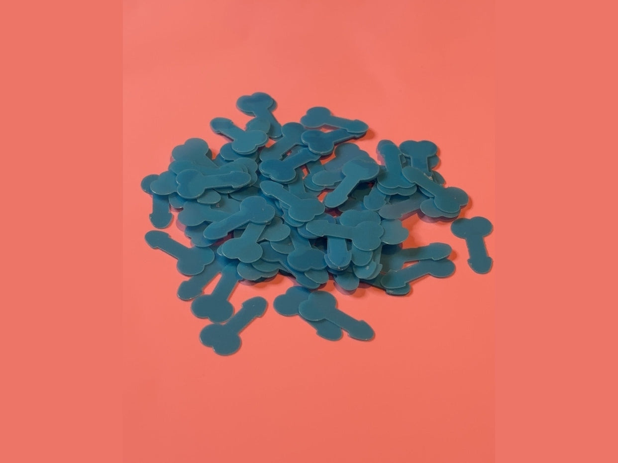 Teal bone-shaped confetti pieces on coral background