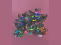GG Glitter Shape black holographic interlocking G logo craft pieces on pink background
