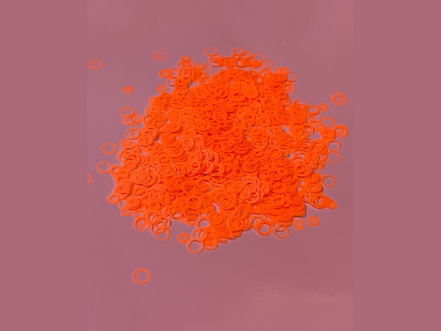 Orange bubble glitter donut-shaped craft beads with fine texture