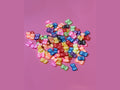 Colorful glossy plastic butterfly charms in assorted bright shades for crafts