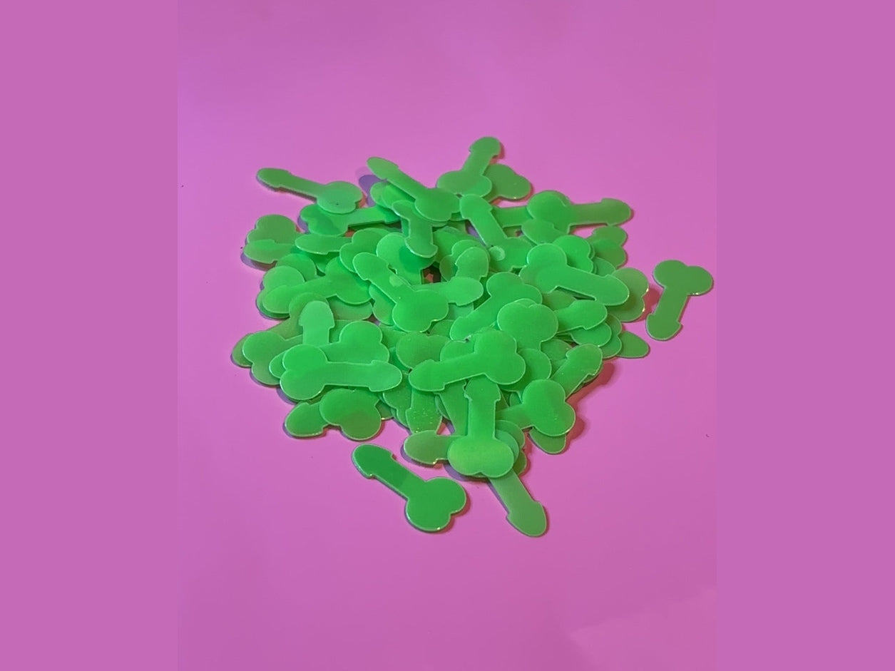 Bright green bone-shaped confetti on pink background