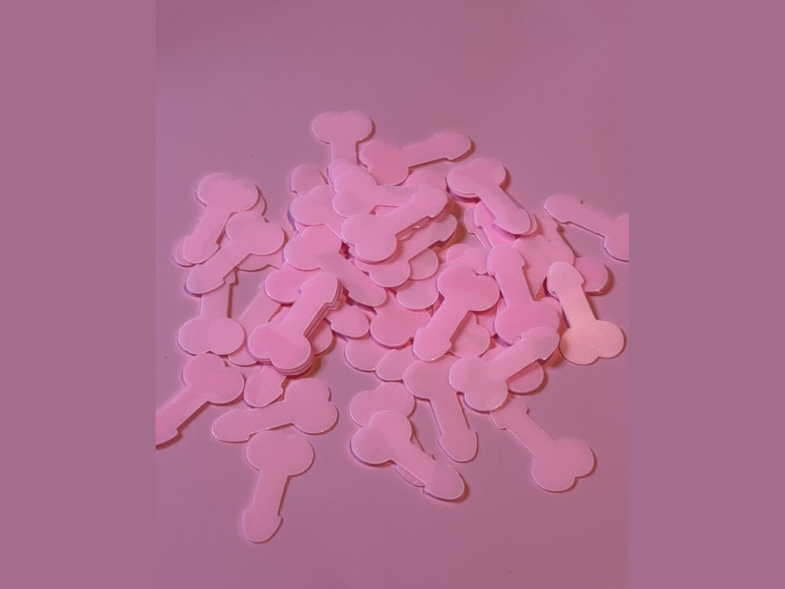 Pink bone-shaped confetti for glow in the dark party decor