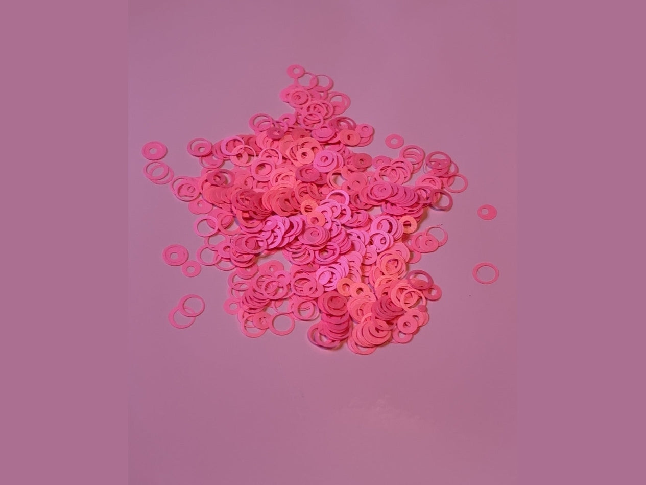 Light pink bubble glitter with ring-shaped pieces and central holes