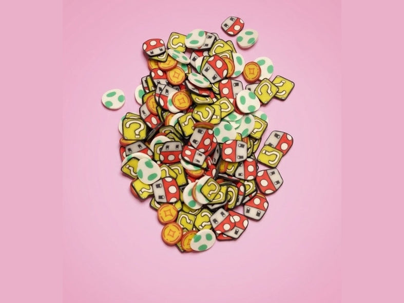 Super Mario Mix polymer clay charms featuring Goomba mushrooms, Yoshi eggs, question blocks, and coins